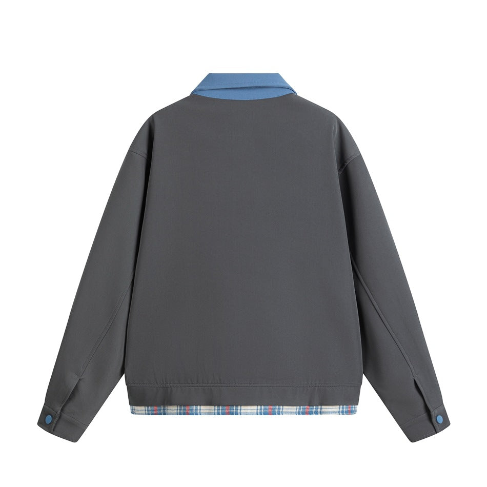 Back view of a charcoal-gray jacket with a blue collar and cuffs, plus blue plaid fabric showing below the hem.