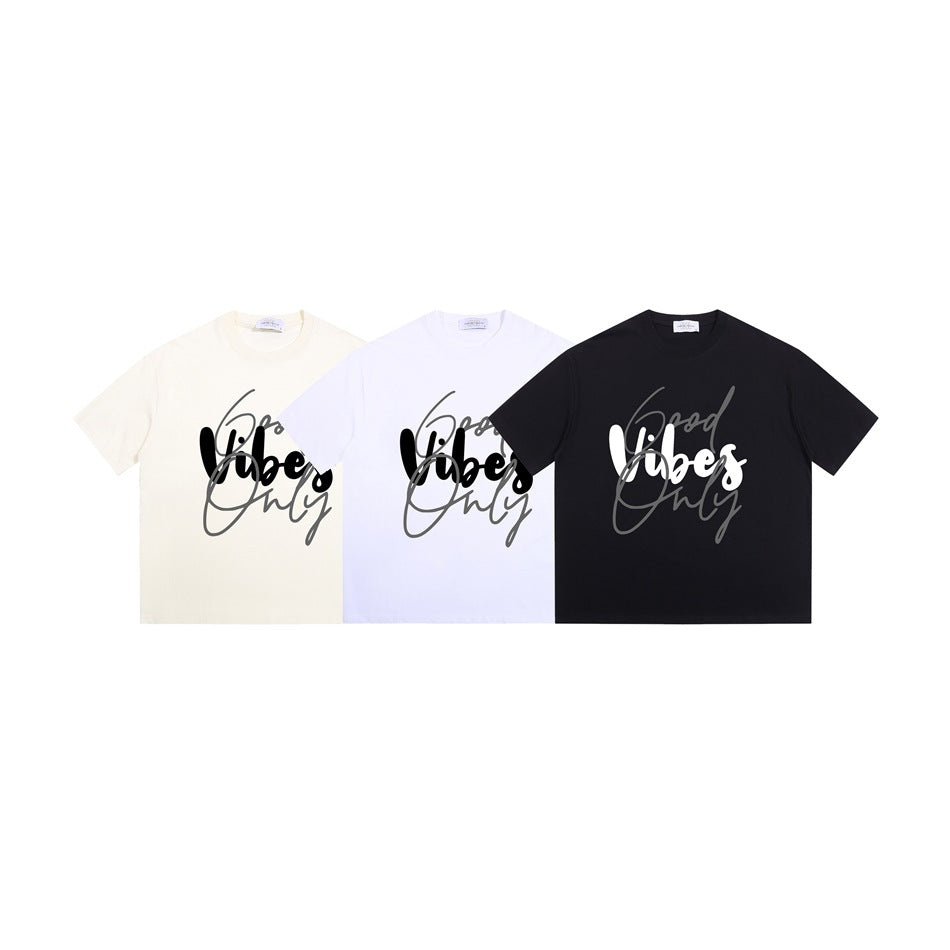 Three crew-neck graphic T-shirts in ivory, white, and black, each with a script front print.