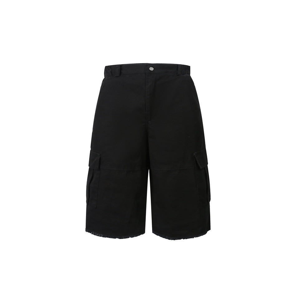 Front view of black knee-length cargo shorts with button waist, side flap pockets and raw frayed hems
