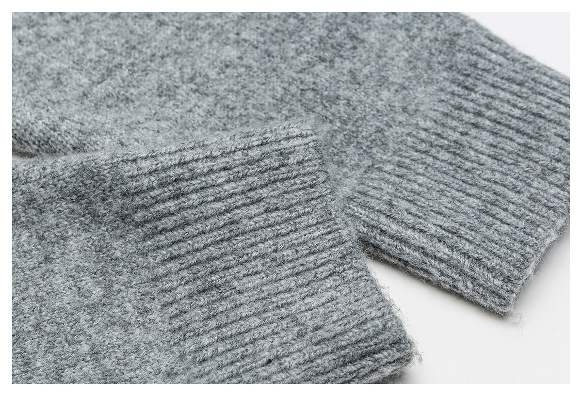 Close-up of a gray knitted garment showing thick ribbed cuffs and a soft textured knit.