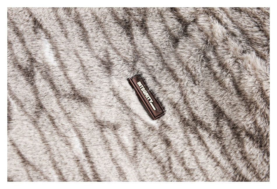 Close-up of gray and beige striped faux fur with a small dark brand label.