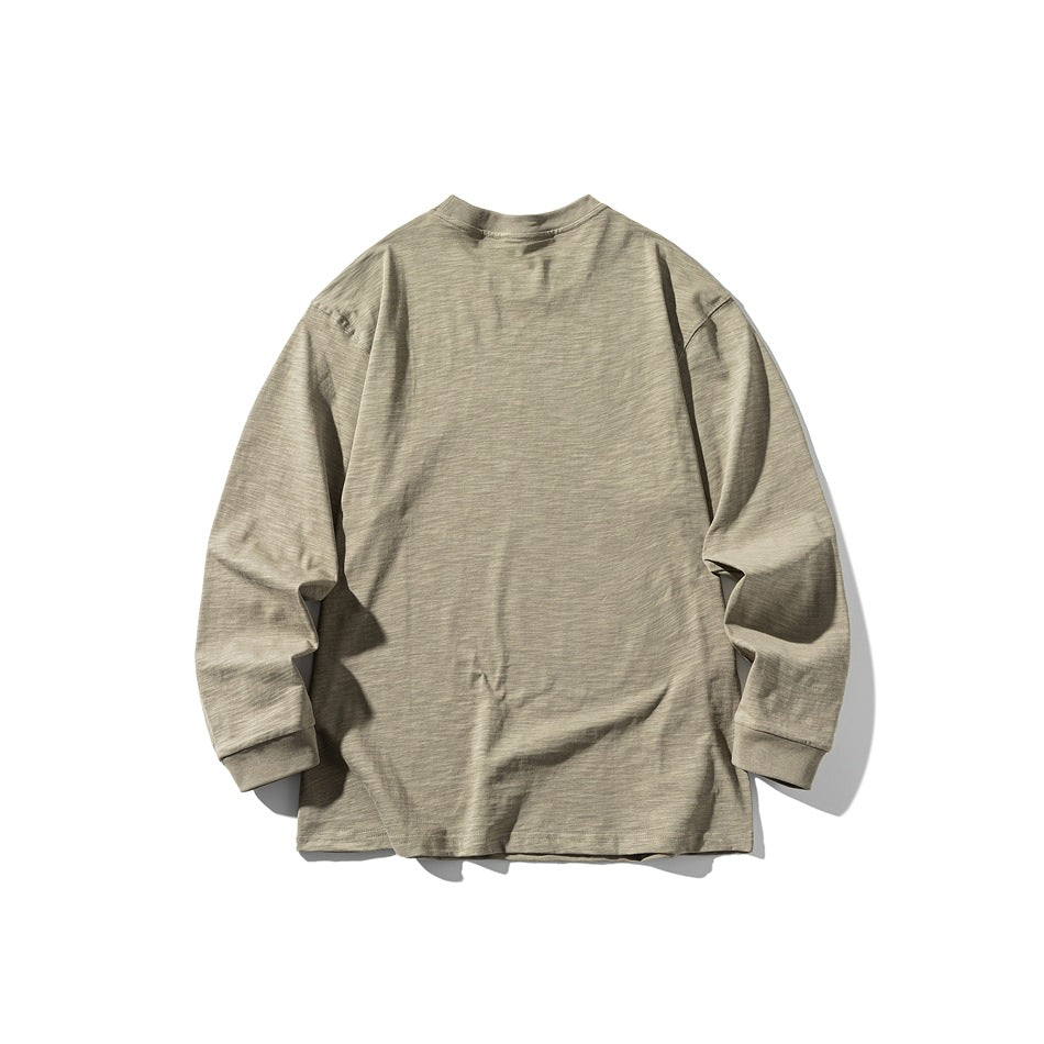 Back view of a light khaki long-sleeve crew-neck shirt laid flat against a white background.