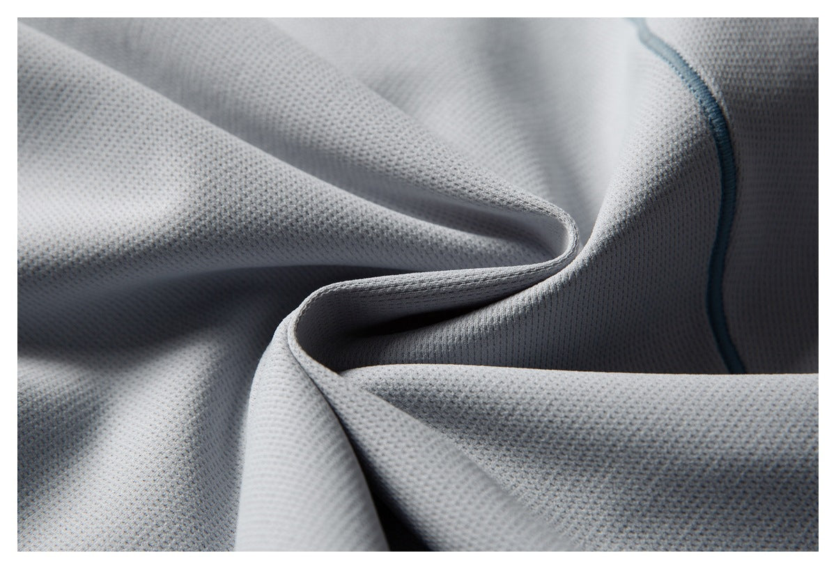 Folded light gray mesh fabric with a curved edge and blue seam finish.