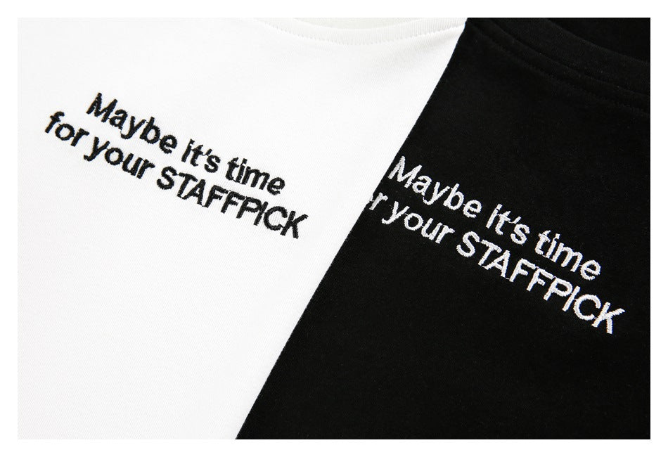 Close-up of the white and black T-shirts showing the printed phrase “Maybe it’s time for your STAFFPICK.”