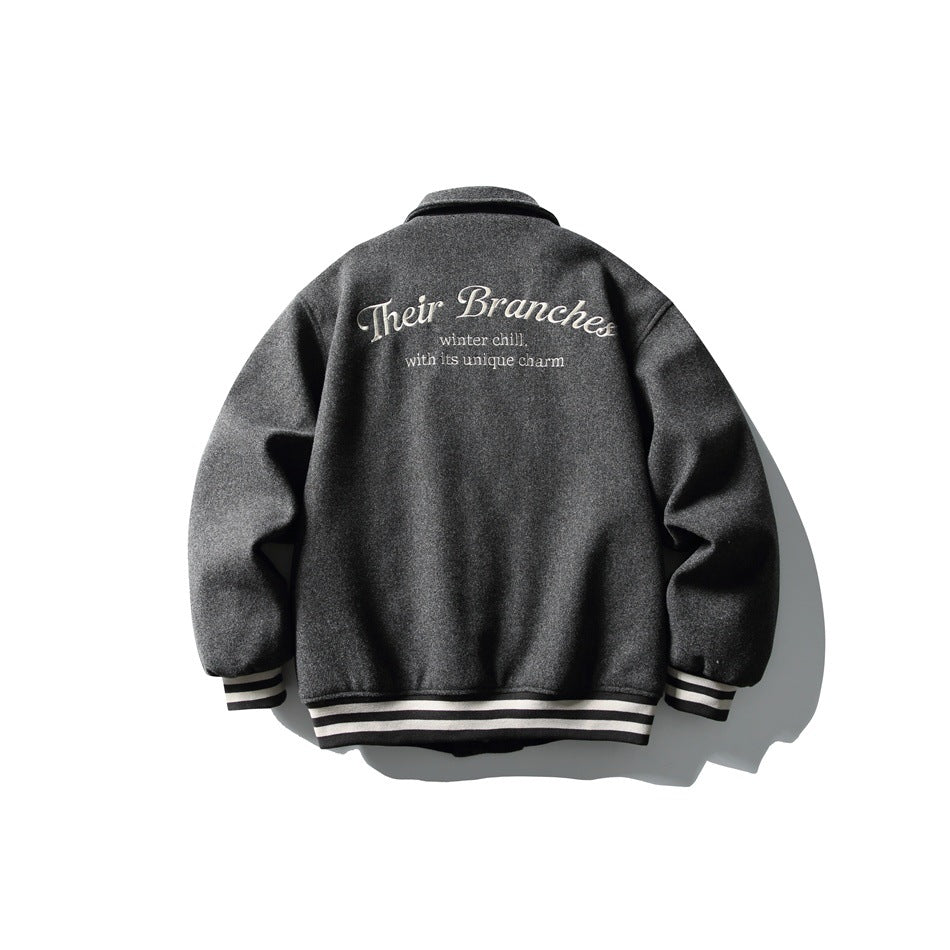 Back view of a charcoal gray jacket with cream script across the shoulders and striped ribbed cuffs and hem.