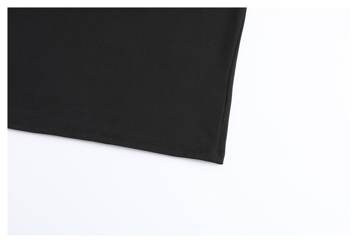 Close-up of the plain black T-shirt body and double-stitched lower hem.