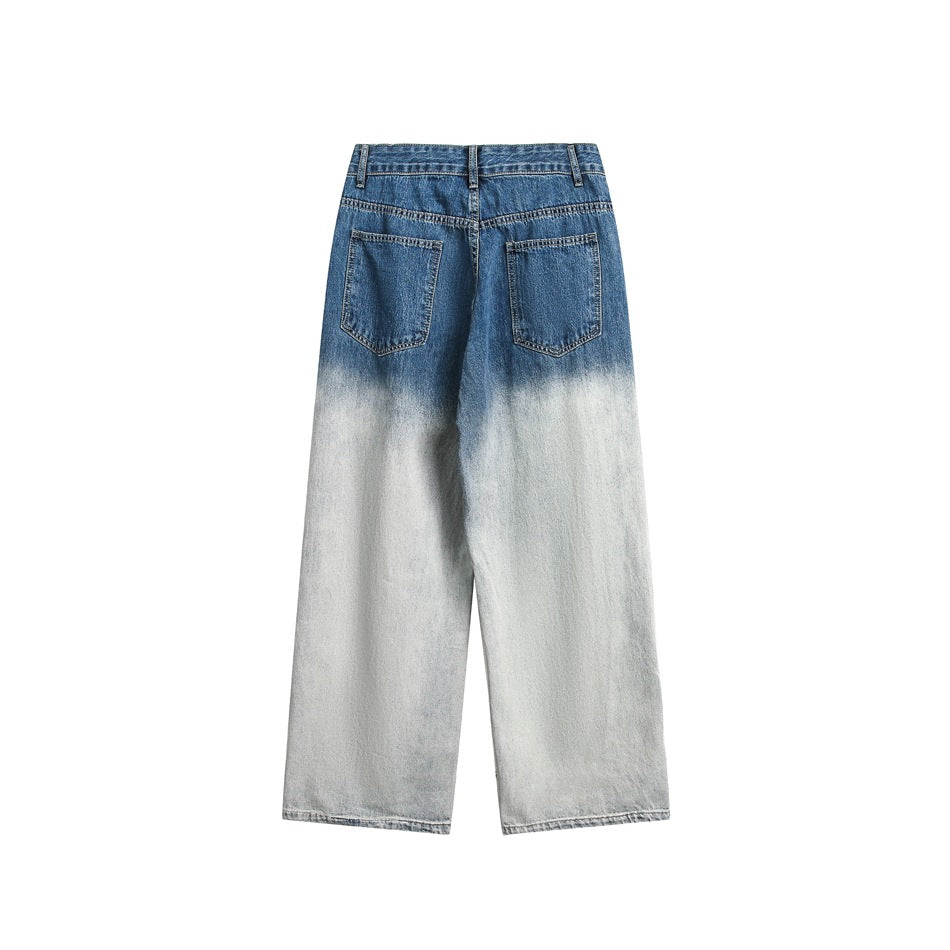Back view of wide-leg jeans with two patch pockets and a blue upper section fading to pale gray-blue legs.