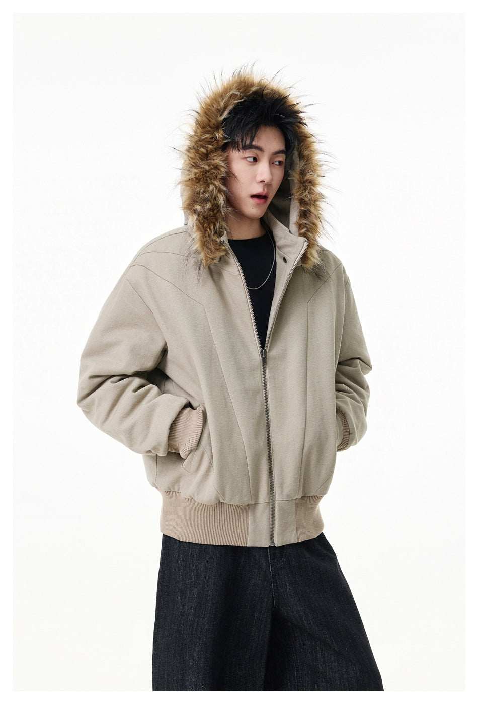 Model wearing a light beige zip-front jacket with the tan fur-trimmed hood raised.