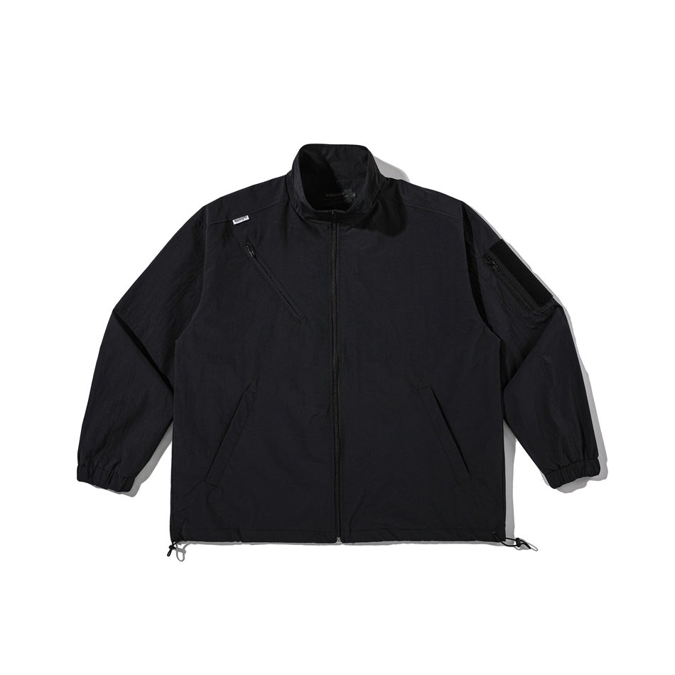 Black stand-collar full-zip jacket flat lay with diagonal chest zip, sleeve pocket, elastic cuffs and drawcord hem