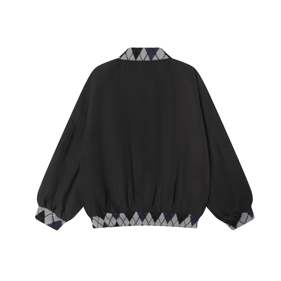 Back view of a black jacket with patterned knit collar, cuffs, and hem.