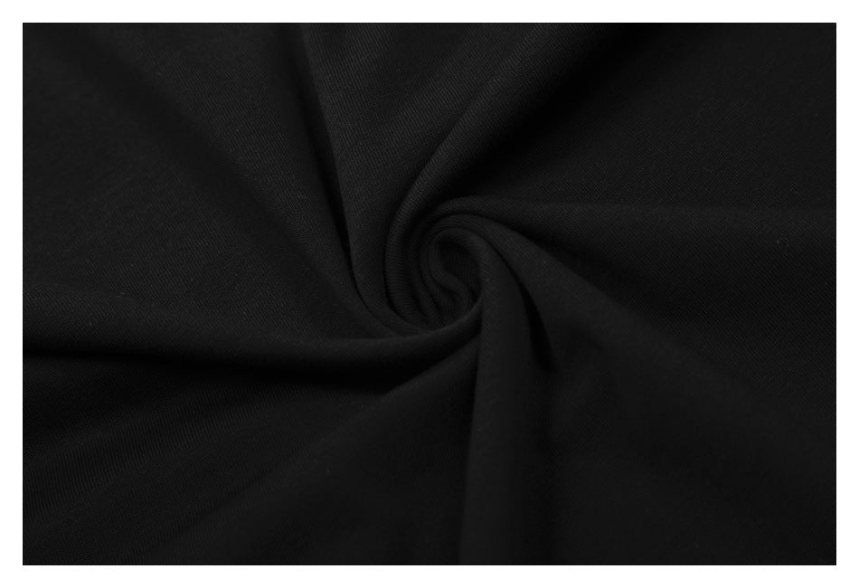 Close-up of black fabric gathered into a swirl, showing its smooth surface and drape.