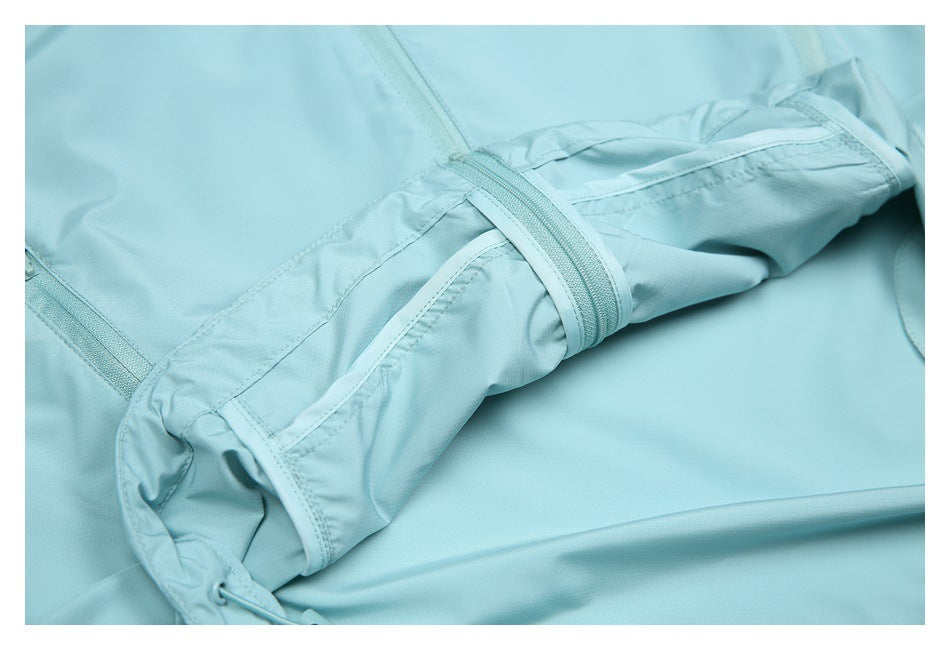 Close-up of aqua garment construction with stitched panels, straps, and a zipper.