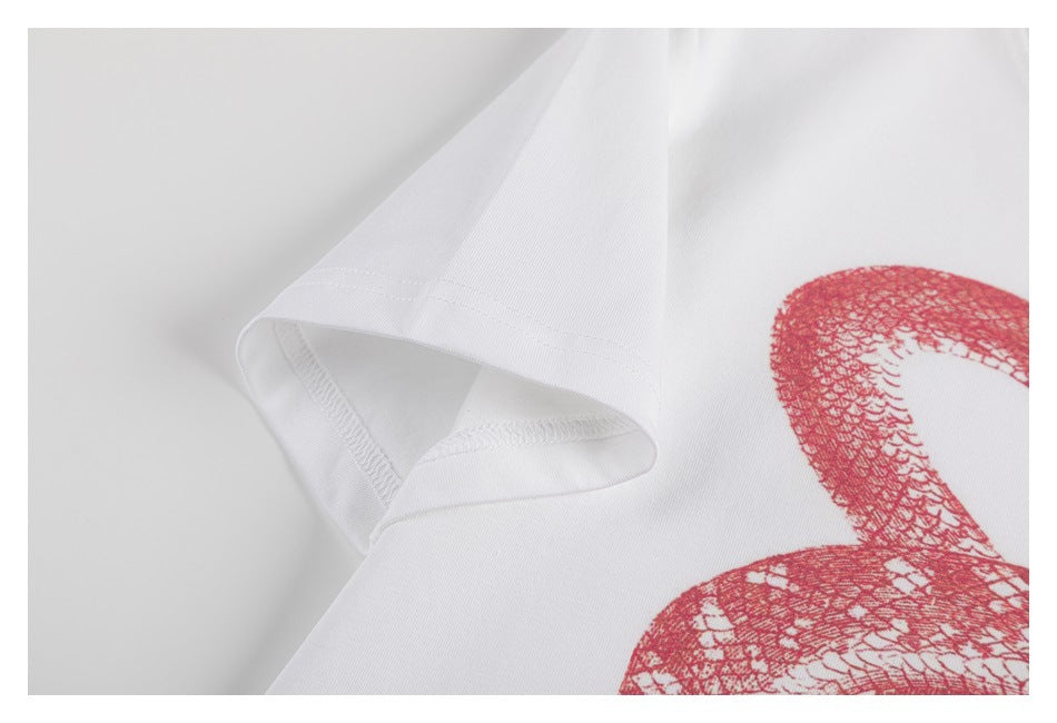 Close-up of a white short sleeve and part of a red printed graphic.