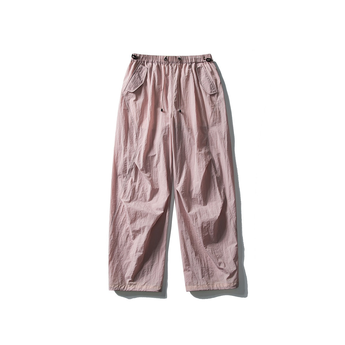Blush pink wide-leg pants with drawstring waist and flap pockets, flat lay front view