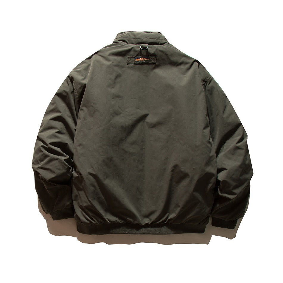 Back view of a dark olive jacket with a stand collar, ribbed hem and cuffs, and a small upper-back patch.