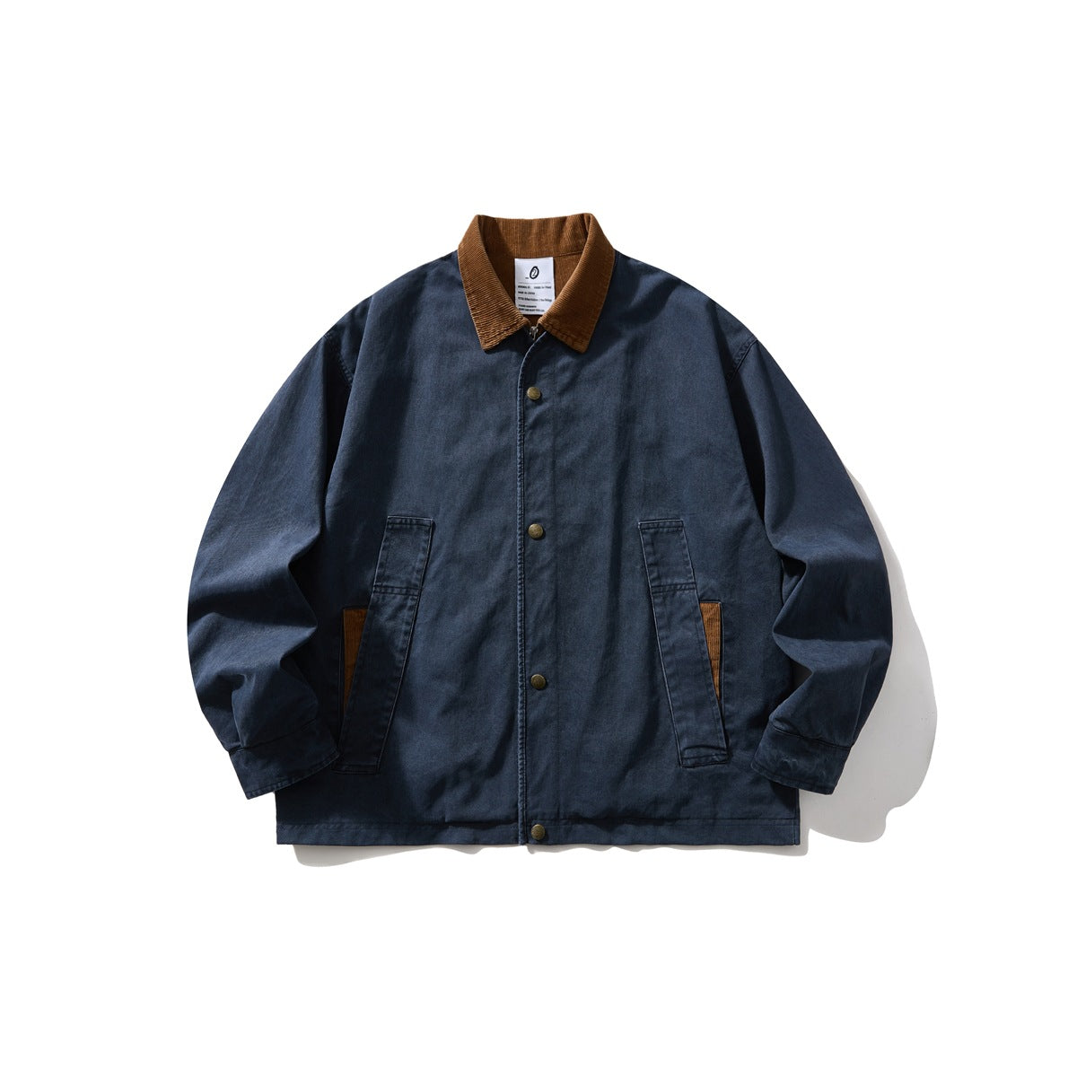 Navy blue collared jacket with brown corduroy collar, snap-button front and two flap pockets, flat lay