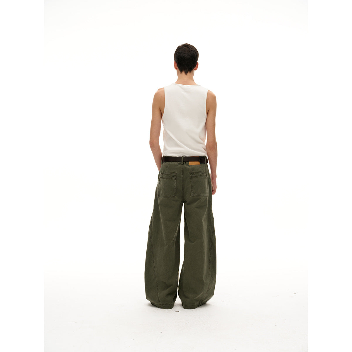 Back view of a model wearing olive wide-leg pants with two rear pockets and a white tank top.