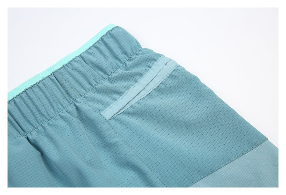 Close-up of the back of blue shorts showing the elastic waistband and a rear pocket.