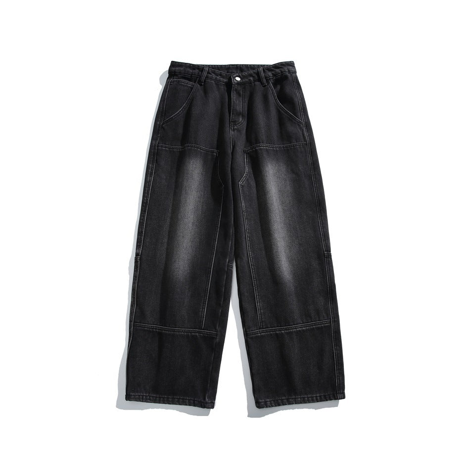 Black washed wide-leg jeans flat lay front view with paneled thighs and knees and contrast stitching