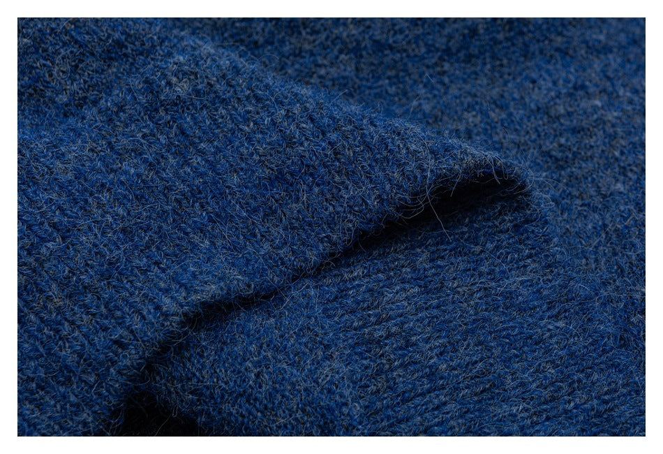 Close-up of blue knit fabric showing its textured surface and a folded edge.