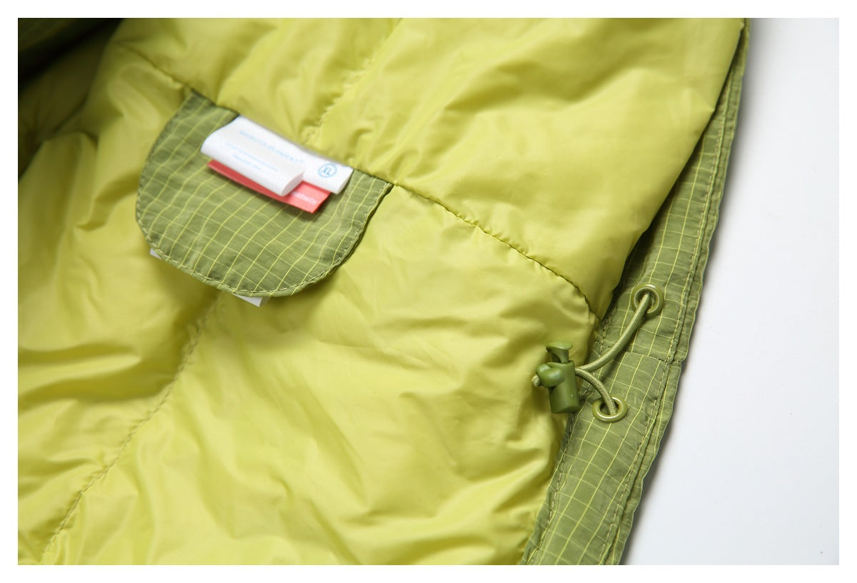 Close-up of the light yellow-green lining, sewn-in labels, and an adjustable drawcord at the edge.