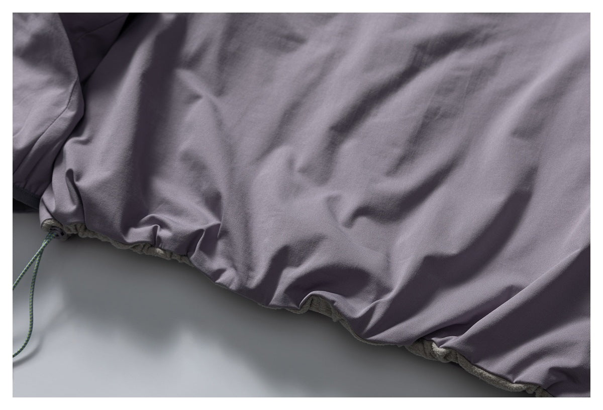 Close-up of a gray jacket hem with an adjustable drawcord.