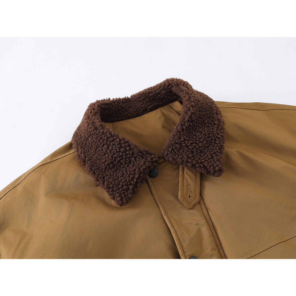 Close-up of a camel-brown jacket with a thick dark brown textured collar and snap-front placket.