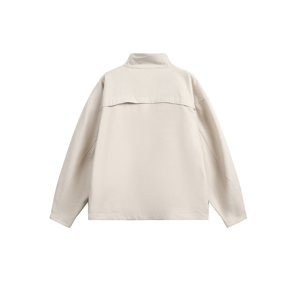 Back view of an off-white jacket with a stand collar, long sleeves, and a horizontal back yoke.