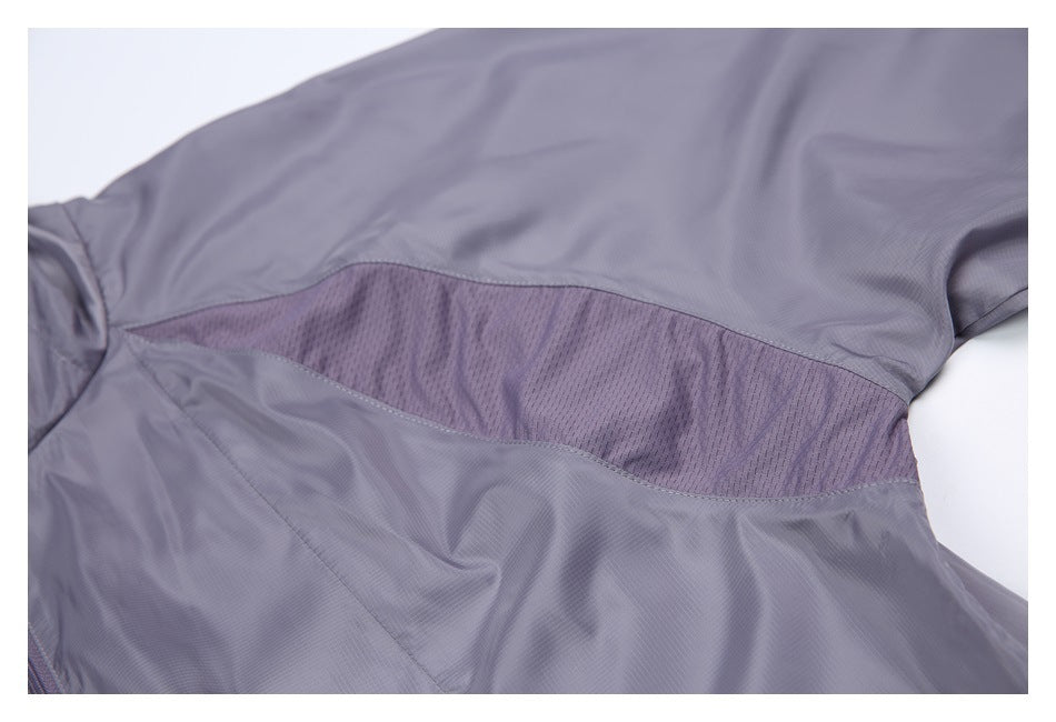 Close-up of a gray-purple jacket with a curved purple mesh ventilation panel across the back.