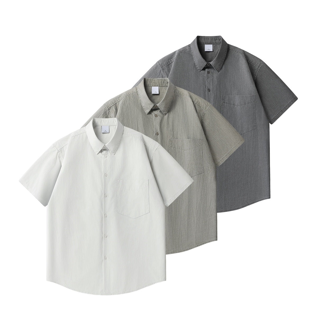 Three short-sleeve button-up shirts with chest pockets, shown in white, light gray, and charcoal.