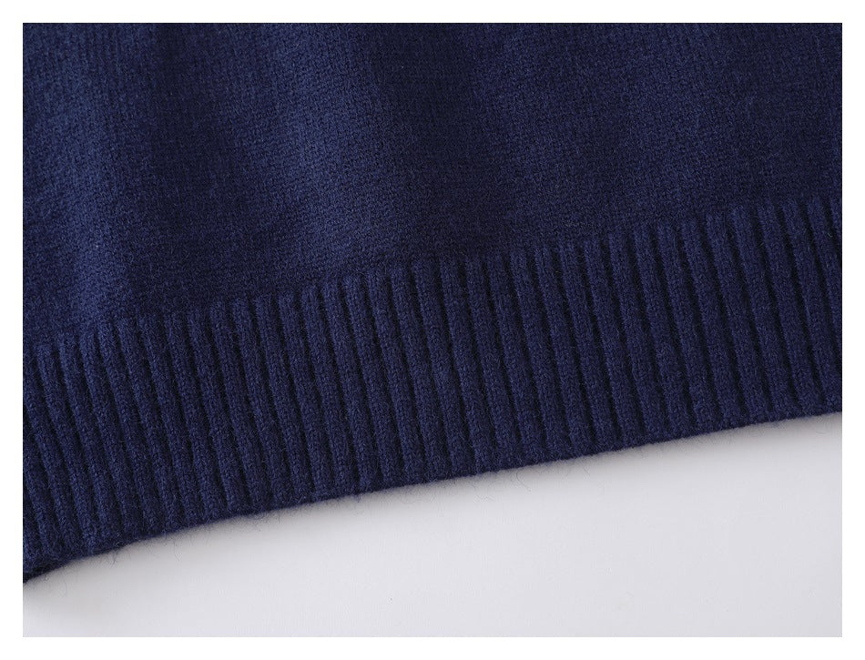 Close-up of a dark navy knit garment with a wide ribbed edge.