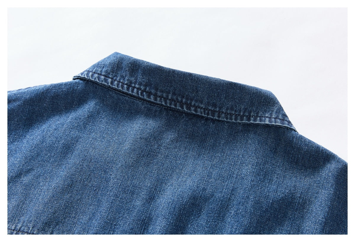 Close-up of the back collar and shoulder area of a blue denim shirt.