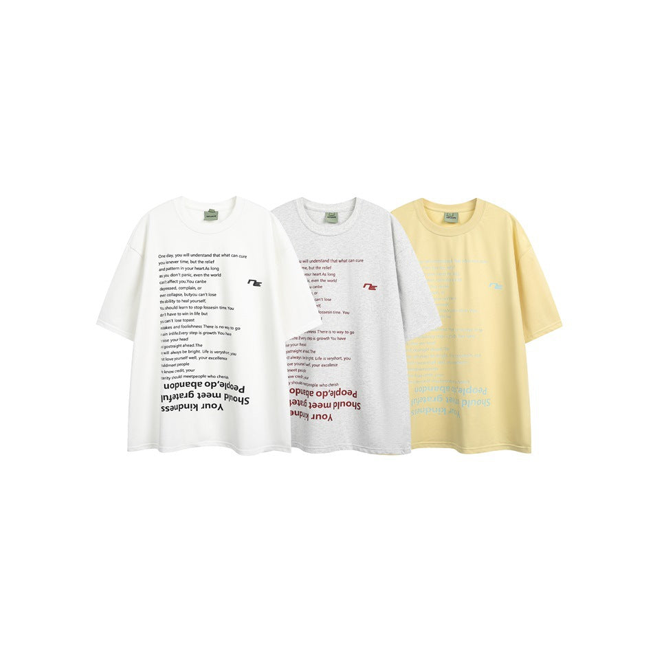 Three oversized short-sleeve T-shirts in white, heather gray, and pale yellow, with English text graphics on the fronts.