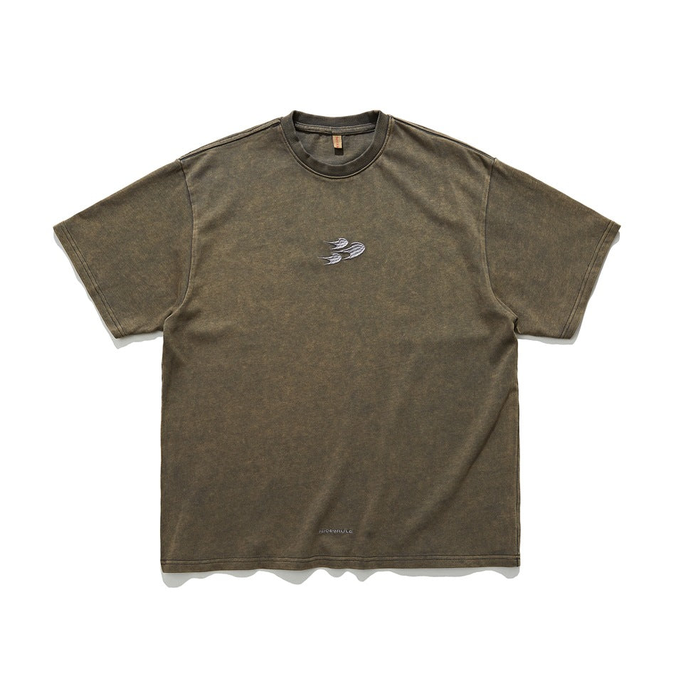 Washed olive-brown short-sleeve crewneck T-shirt with a small silver embroidered emblem on the chest, flat front view