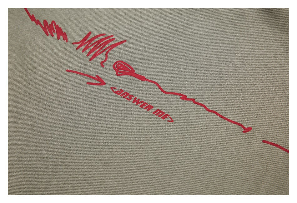 Close-up of muted olive-gray fabric with red line-art and lettering printed across it.