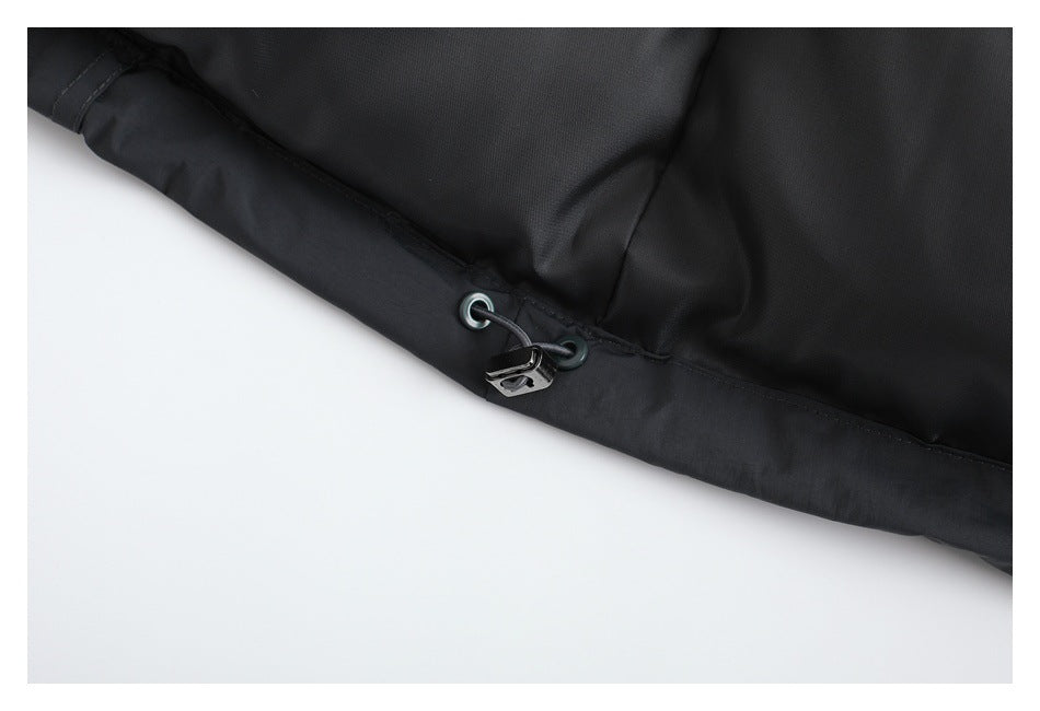 Close-up of a black garment hem with metal eyelets, an elastic drawcord, and a toggle.