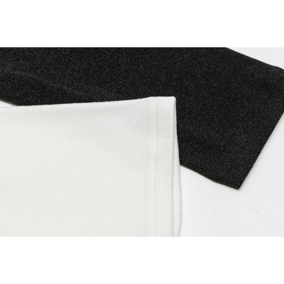 Close-up of white and charcoal fabric edges with visible stitching.