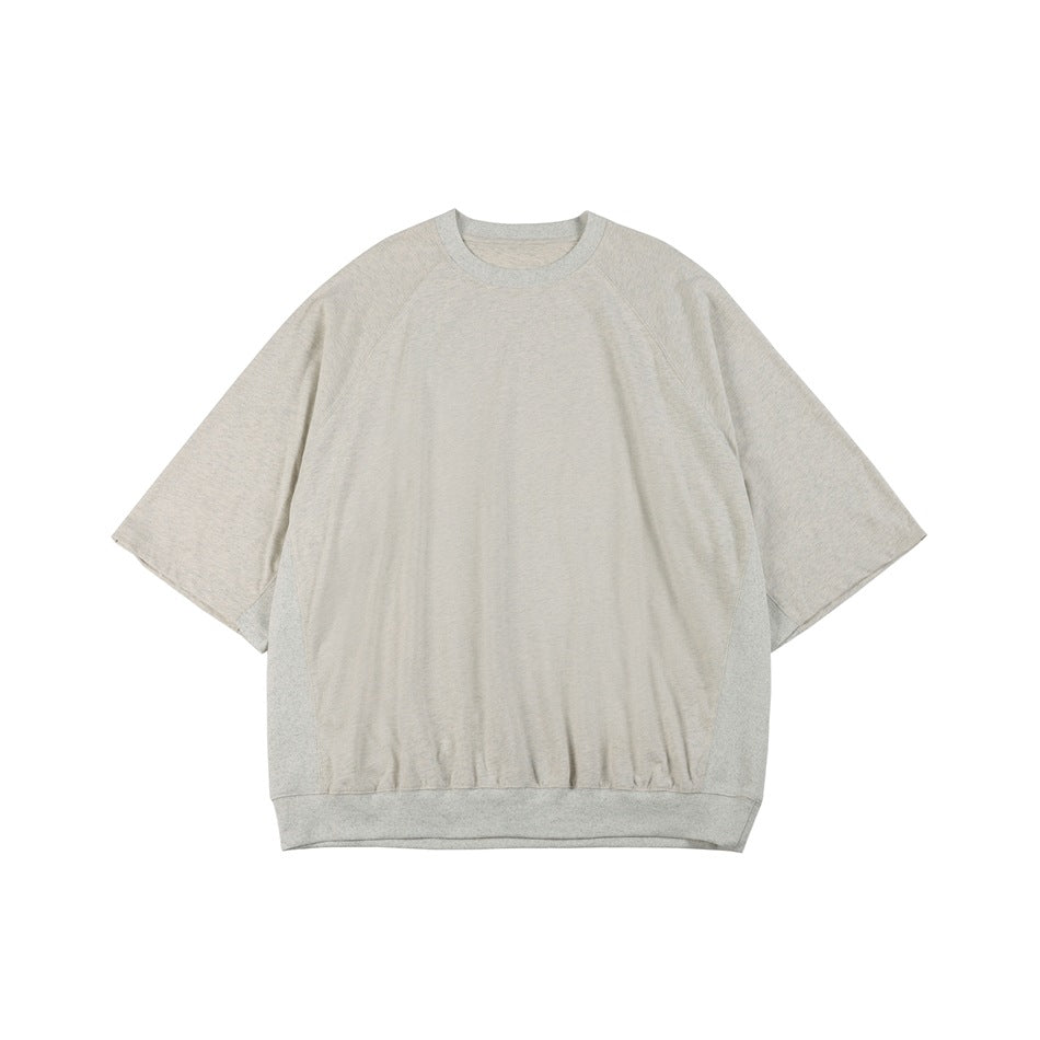 Light heathered gray oversized raglan tee with ribbed neck and hem, flat lay front view