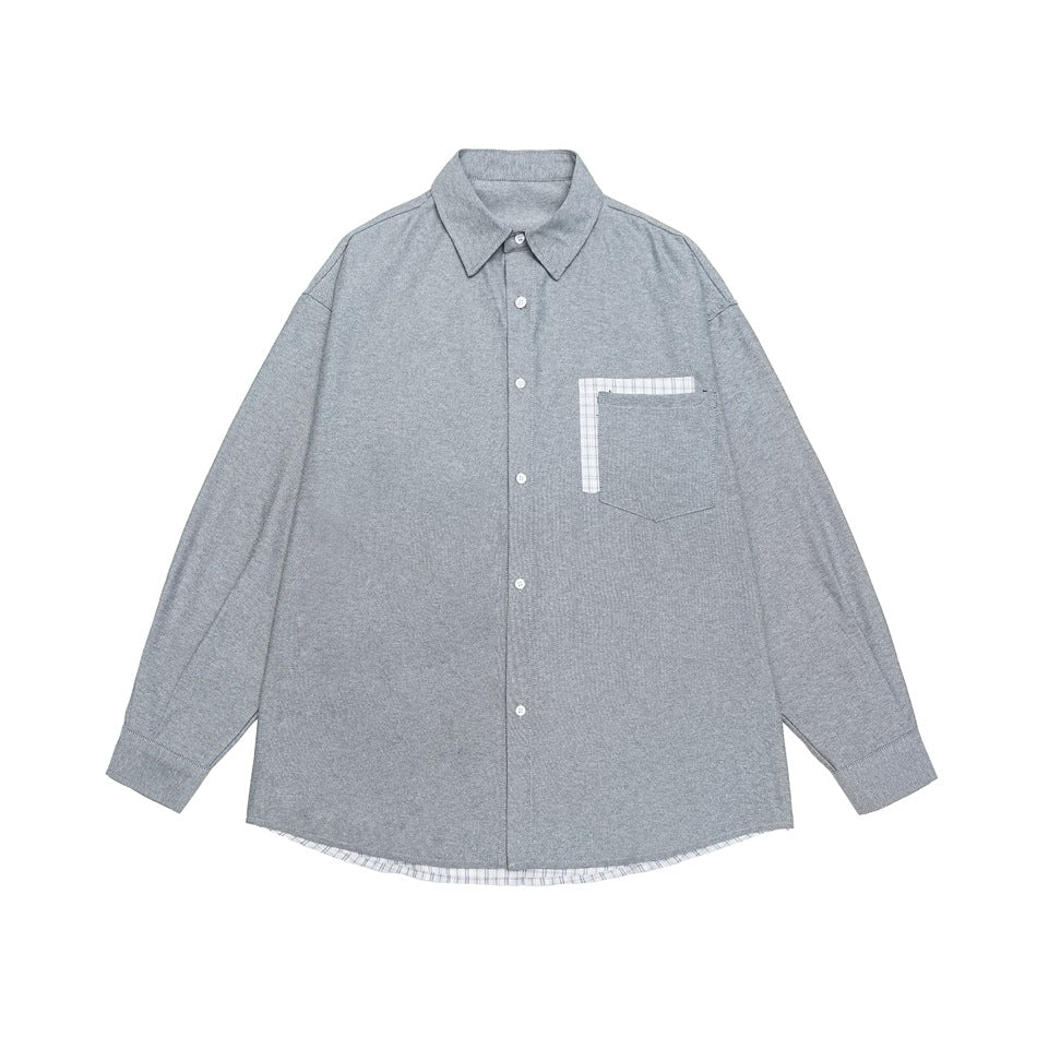 Gray long-sleeve button-up shirt flat lay with plaid-trimmed chest pocket and plaid hem layer