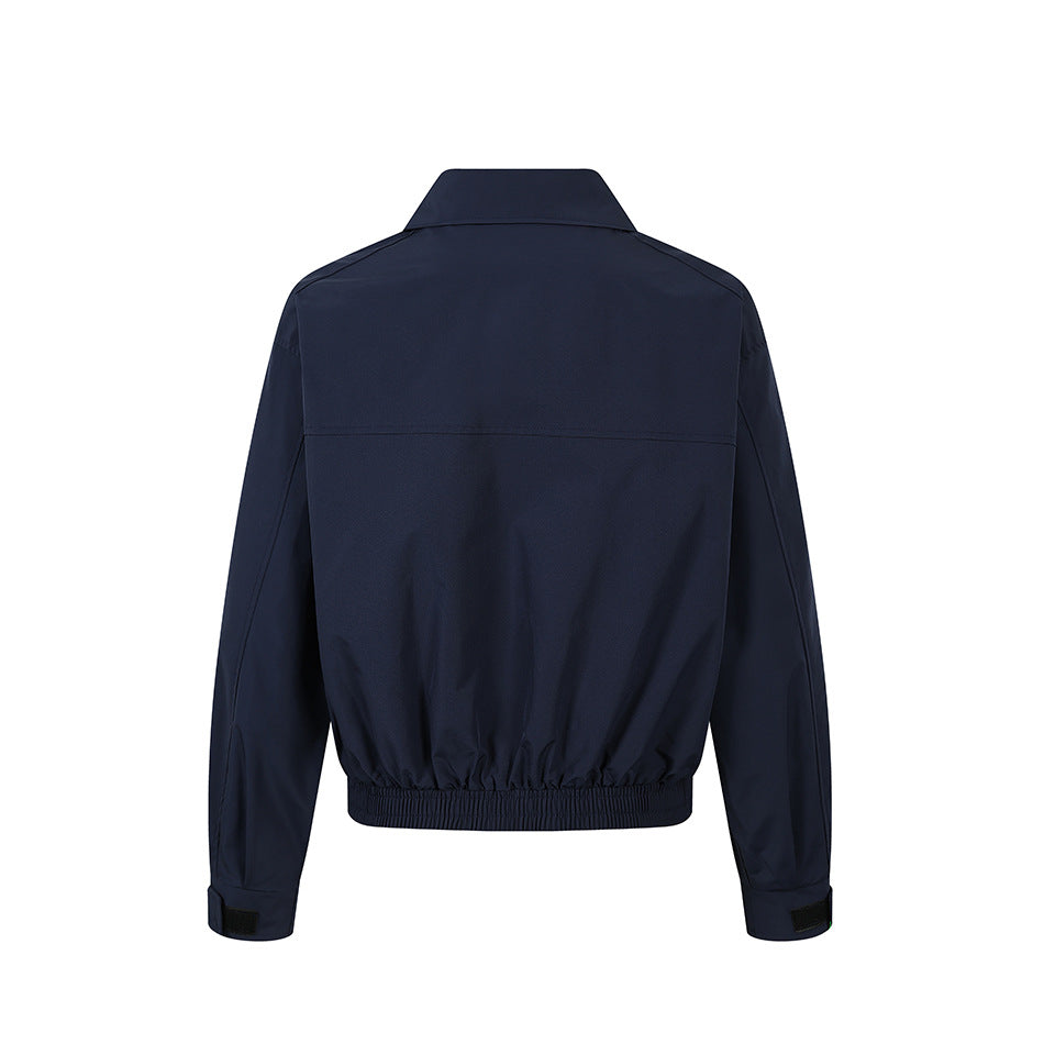 Back view of a dark navy jacket with a stand collar, long sleeves, and gathered elastic hem.