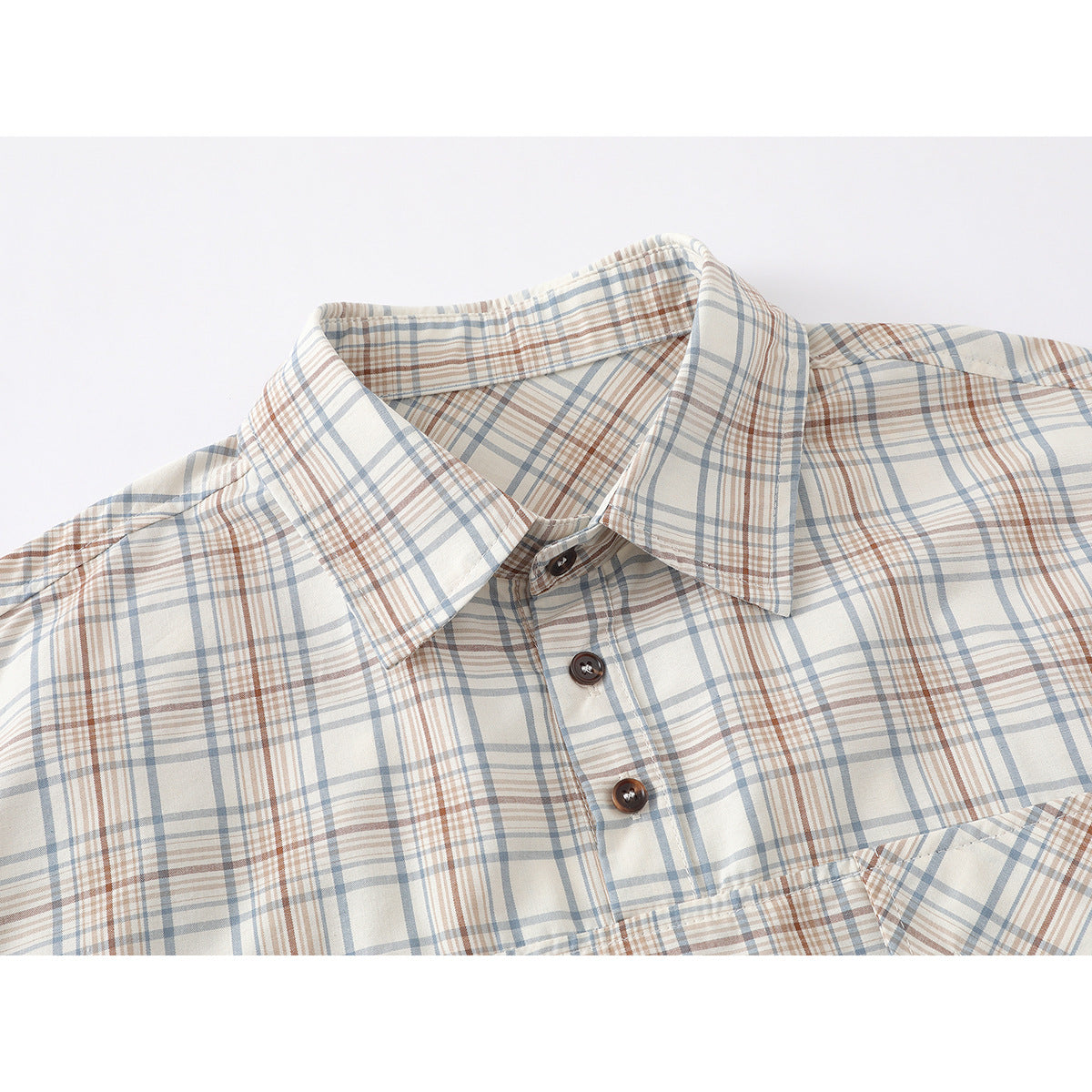Close-up of a cream plaid shirt collar and brown buttons, with blue-gray and rust lines.