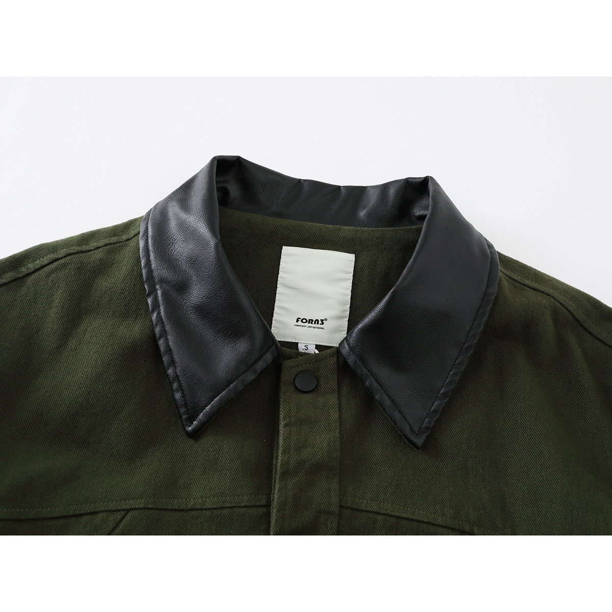 Close-up of an olive green jacket with a wide black collar, black snap button, and visible inner neck label.