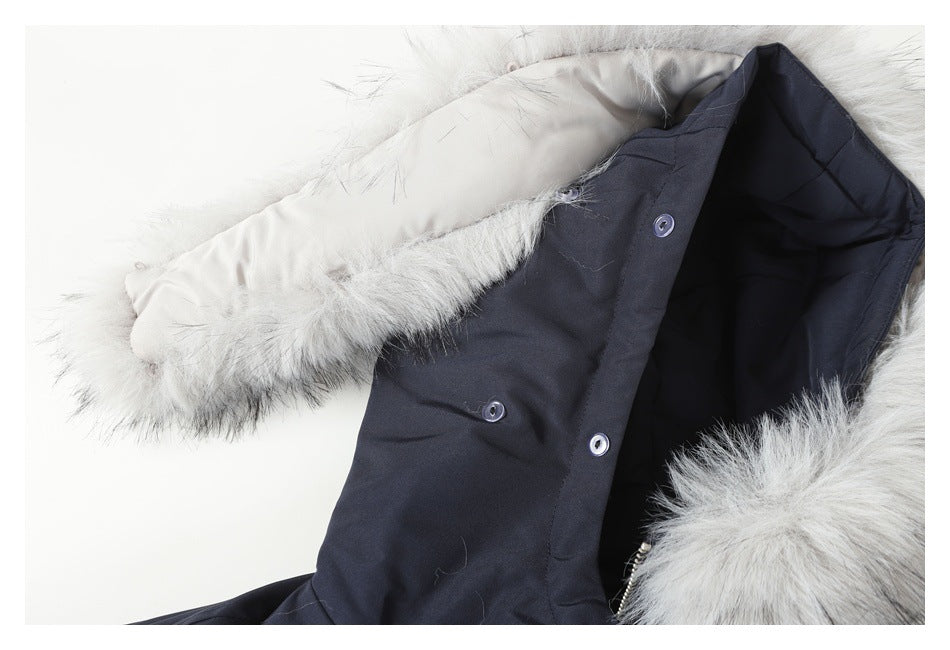 Close-up of the navy jacket hood with pale faux-fur trim and snap fasteners.