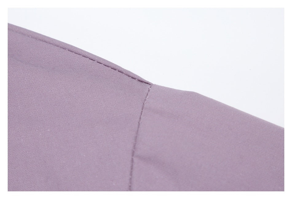 Close-up showing the mauve garment's shoulder seam and fabric.