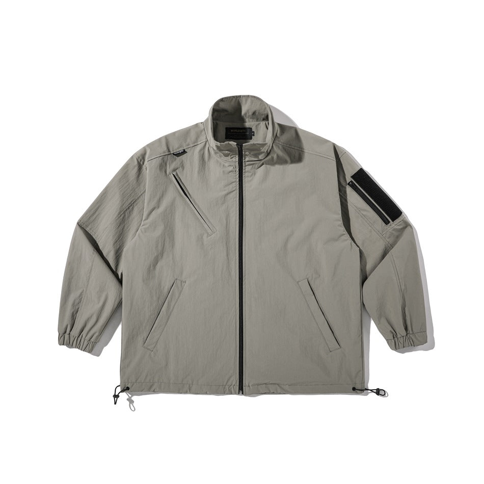 Gray stand-collar full-zip jacket flat lay with chest zip pocket, sleeve patch pocket, elastic cuffs and drawcord hem