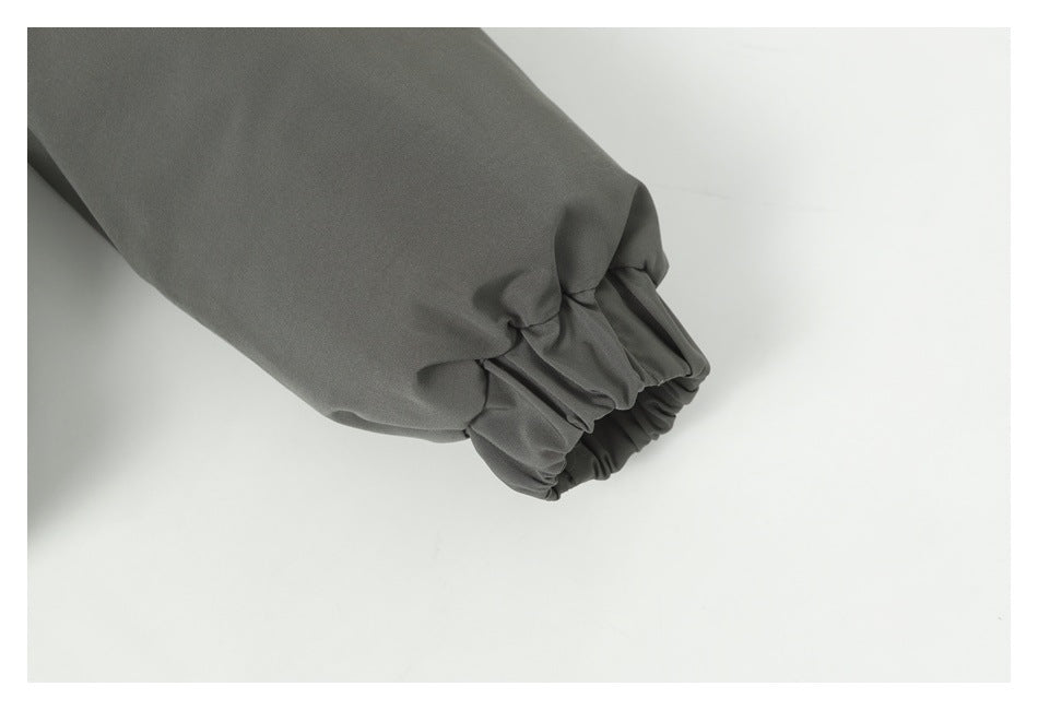 Close-up of a gathered elastic cuff on a dark gray jacket sleeve.