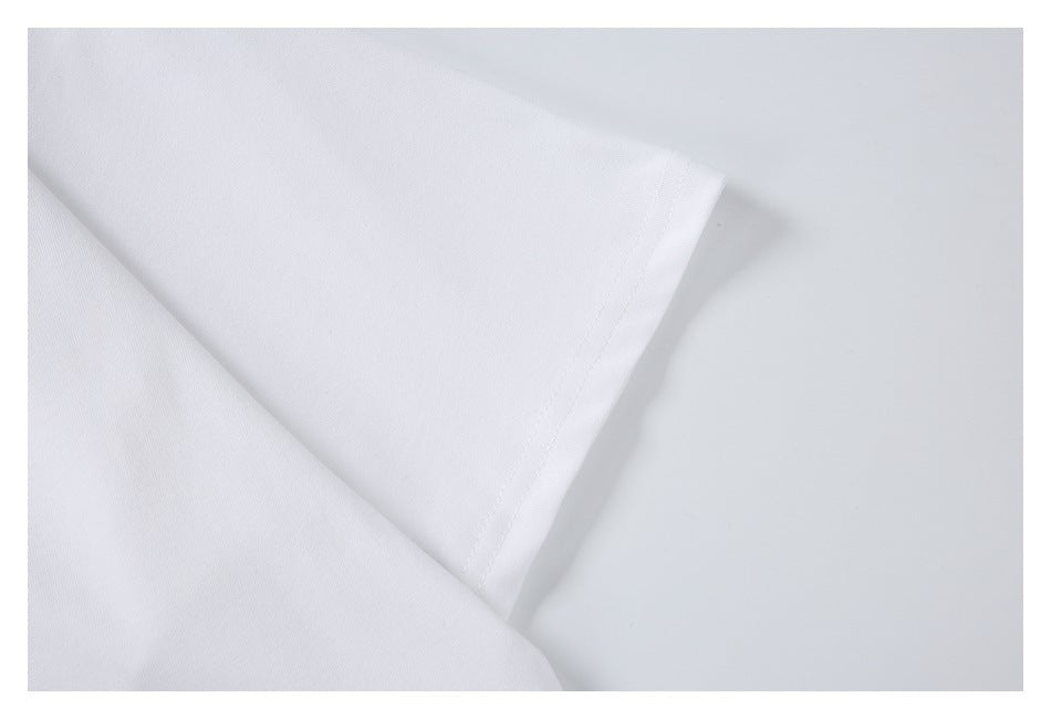 Close-up of the stitched sleeve hem on a white T-shirt laid flat.