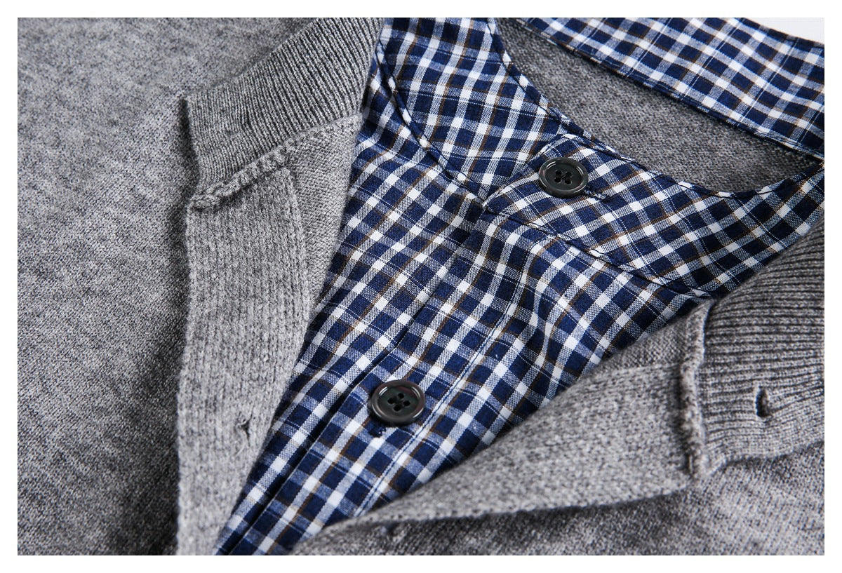 Close-up of a gray sweater opening with navy-and-white checked lining, buttons, and ribbed knit trim.