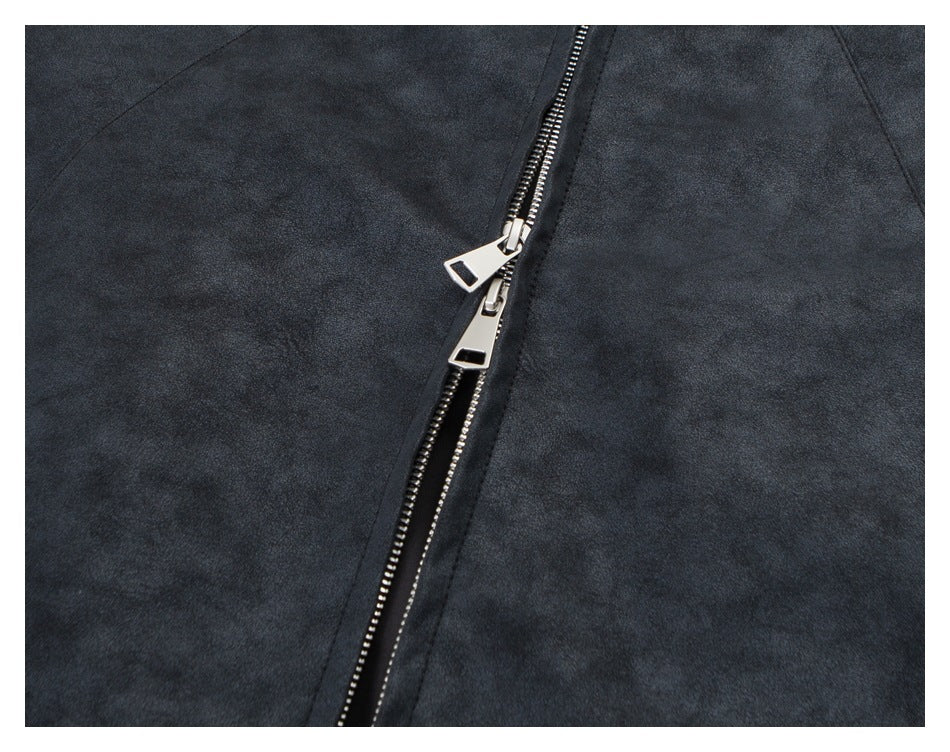 Close-up of the jacket's front zipper with two silver pulls on dark charcoal fabric.