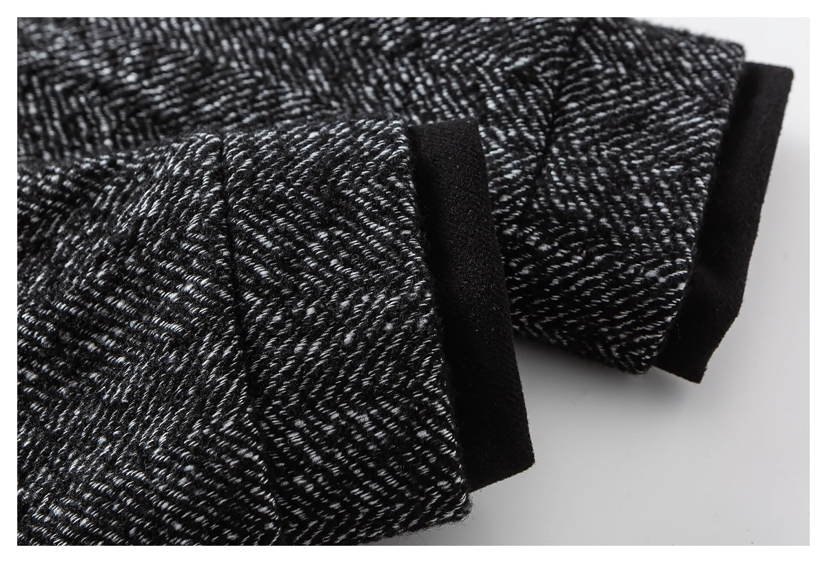 Close-up of black-and-white herringbone fabric with a wide black edge trim.